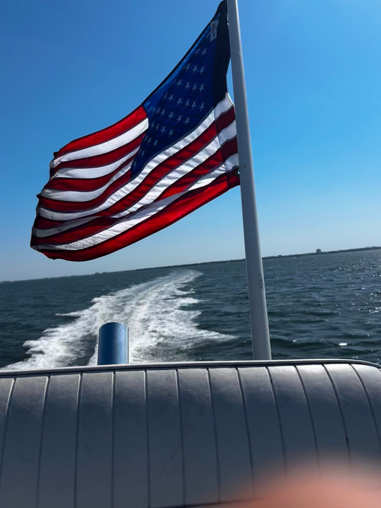 American flag flying off the back of a boat