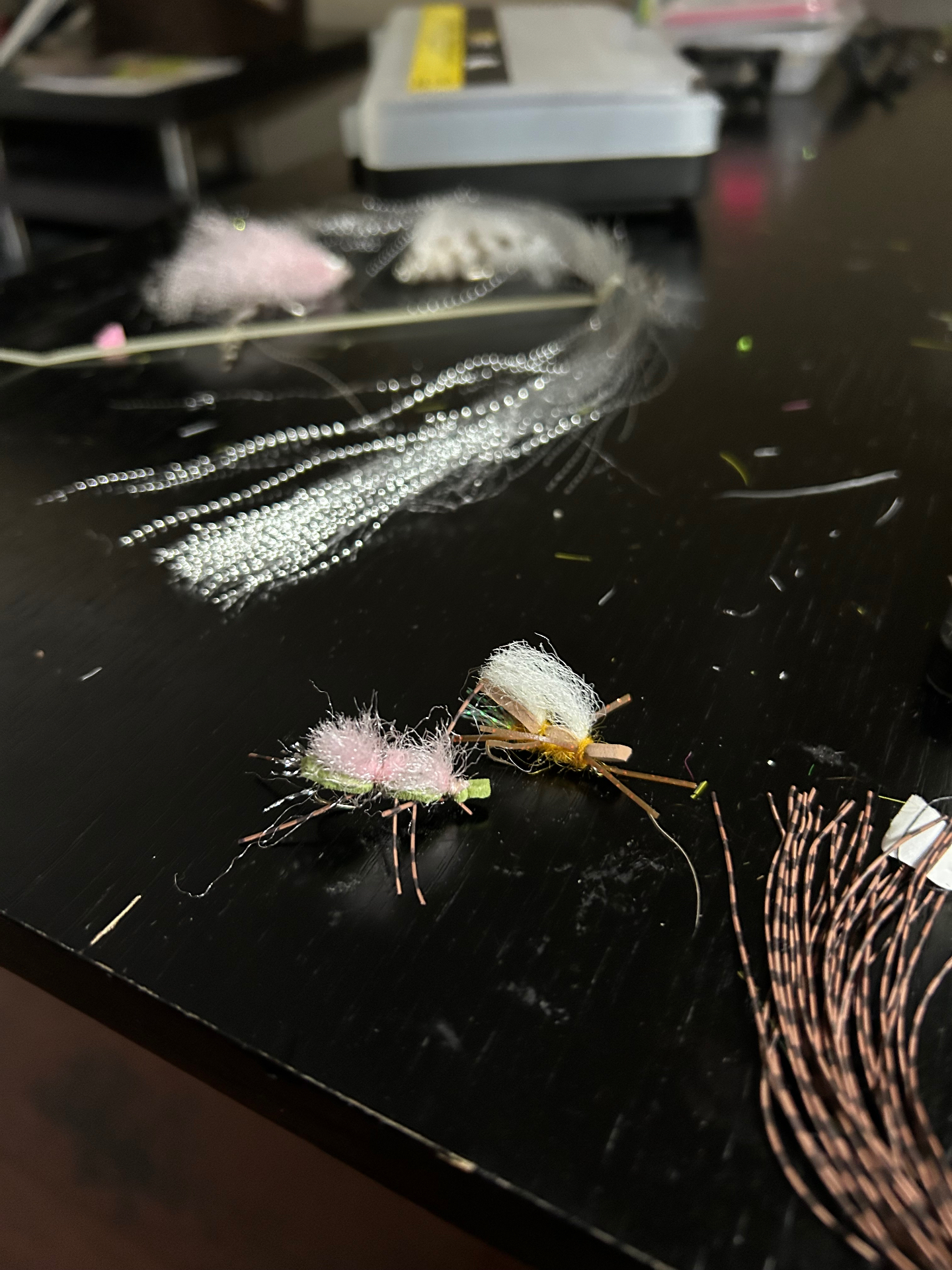 Hands tying a saltwater fly at a workbench